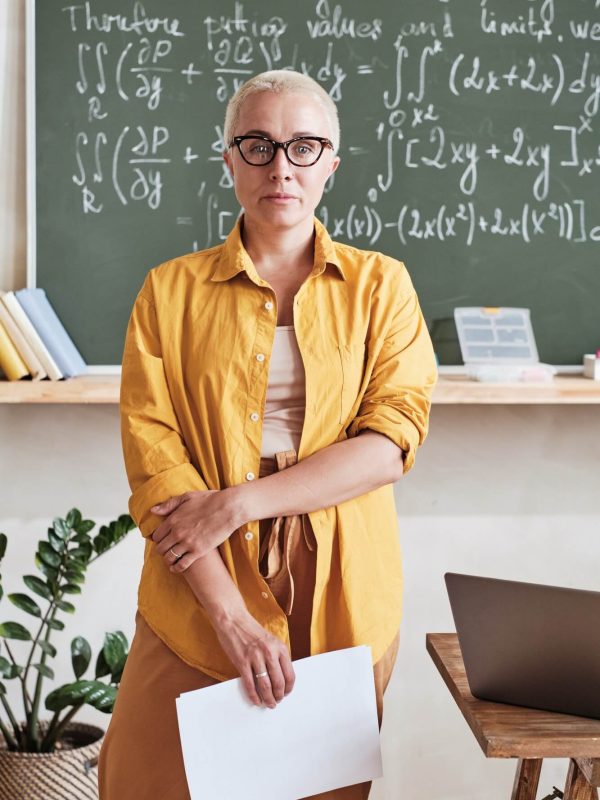 teacher-standing-in-the-classroom-at-school-1.jpg